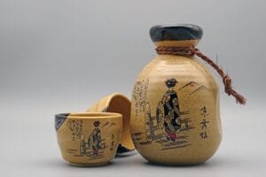 A traditional ceramic jug and cup set used for serving tuak rice wine or other Asian spirits.