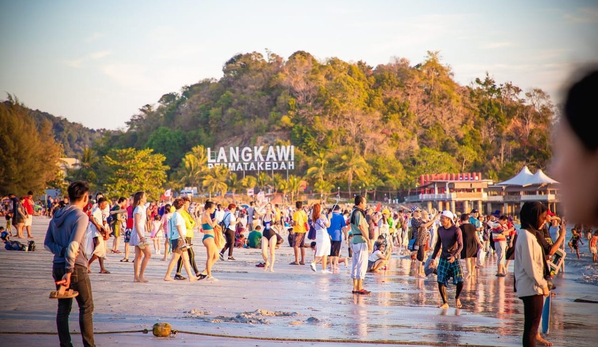 best-beaches-in-langkawi-tourist-sign Tourists gathering near the iconic landmark sign in Langkawi, a top destination known for the best beaches in langkawi.